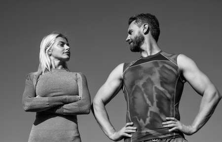confident sport man and woman in sportswear relax on sky background, fitnessの写真素材