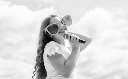 music is my life. kid sing with mic. cheerful event manager. child have fun on party. happy singer with microphone. girl singing. vocal school concept. karaoke clubの写真素材