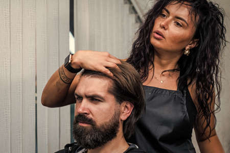 style your hair. brutal bearded man at hairdresser salon. hair wash and care. new stylish haircut.の写真素材