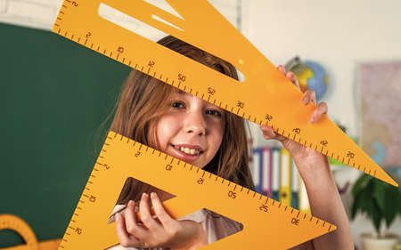 child learn mathematics. college student do homework. teen girl with triangle ruler.
