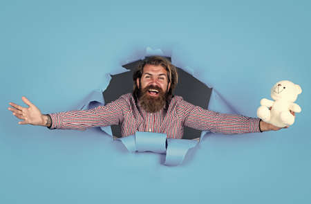 lets celebrate. cyber monday and black friday. best birthday present. mature man with gift toy. guy with beard hold bear present. brutal caucasian hipster with moustache. male shopping conceptの写真素材