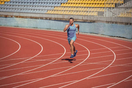 athletic muscular man runner running on stadium, speedの写真素材