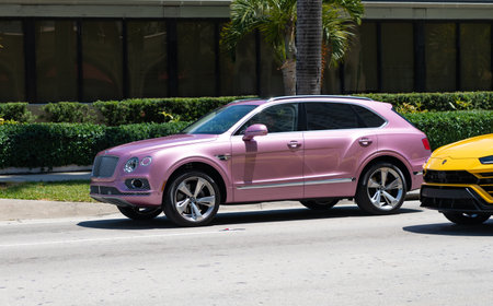 Miami Beach, Florida USA - April 15, 2021: pink metallic Bentley Bentayga v8 2015, front side view.