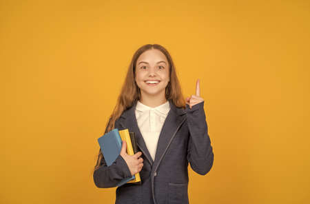 inspired with idea happy kid hold school homework on yellow background, homeworkの写真素材