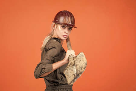 working woman. female builder hold shovel. building and construction.