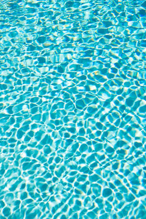 blue color background of swimming pool water with ripples. concept of vacationの写真素材