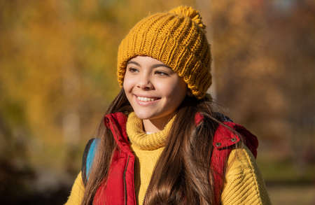 happy teen girl in hat outdoor in autumn seasonの写真素材