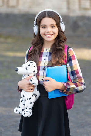 Happy teen girl back to school holding toy, music education. back to school. pupil at school time.