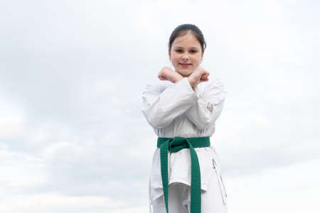 teen girl practicing karate. teen child on sky background. copy space.の写真素材