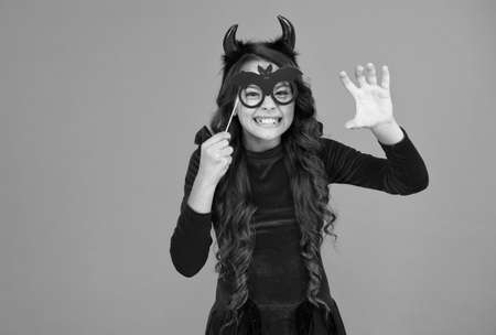 frightening scaring girl in imp horn costume to halloween with funny party glasses, spooky halloweenの写真素材