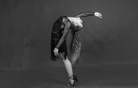 cute child girl in ballroom dress posing while dancing, dancerの写真素材