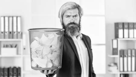 man read piece of paper. office worker digging in garbage bin. businessman hold trashcan. man in office look for lost note in paper bin. crumpled paper in wastepaper basket. selective focusの写真素材