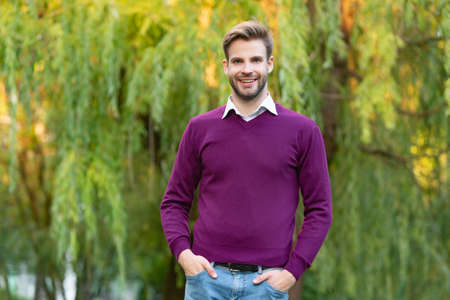 young unshaven man in casual style outdoorの写真素材