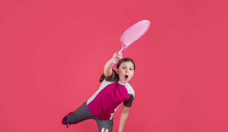 kid playe tennis with racket on pink backgroundの写真素材