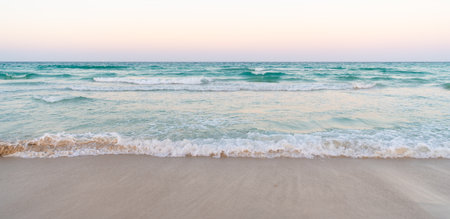 beautiful beach with sea water waves and morning skyの写真素材
