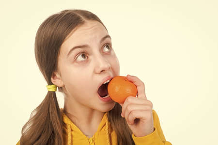 cheerful child with citrus fruit mandarin full of vitamins isolated on white, wellness