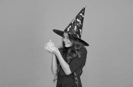 halloween child in witch hat costume with pumpkin, halloween partyの写真素材