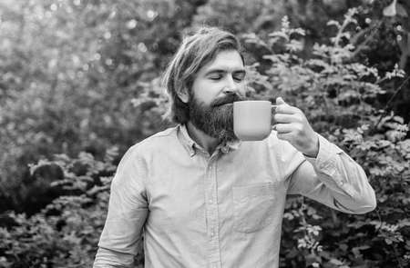 mature man with beard and trendy hairstyle drink coffee, morning