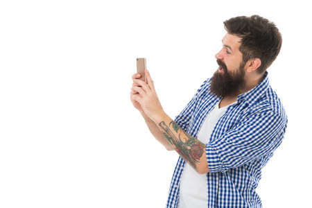 Document every moment. Bearded hipster man hold smartphone or mobile phone white background copy...