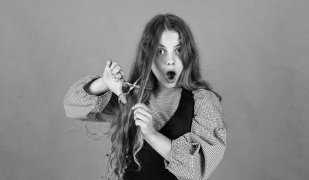 happy teen girl cut hair with scissors, hairdresserの写真素材