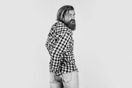 Caucasian mature hipster with trendy hairstyle in checkered shirt having hemorrhoids, male problemsの写真素材