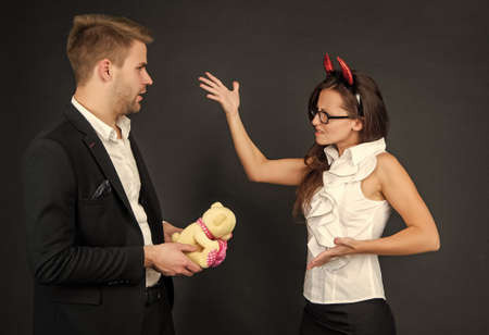 Down with love. Devil woman angry at man. Workplace conflict. Be wicked for Halloweenの写真素材