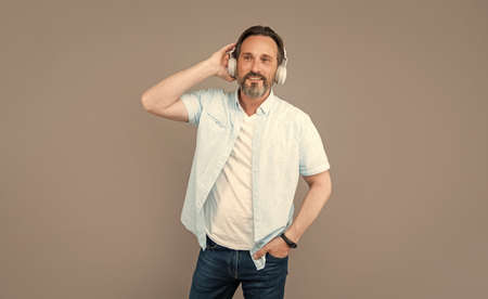 Listen up. Senior man listen to music. Using stereo headphones. Listening songs. Leisureの写真素材