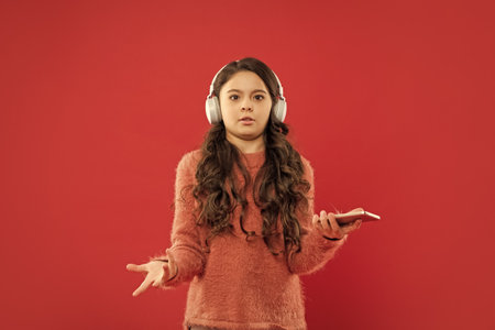 confused kid wear sweater. express emotion. autumn fashion.の写真素材