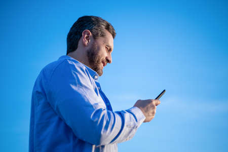 cheerful man chat on smartphone with message. man chatting on phone messaging.