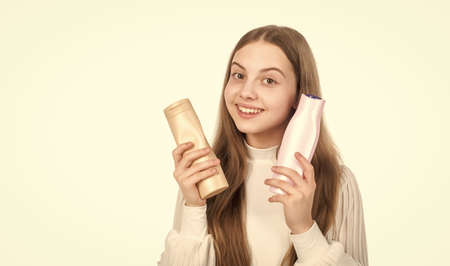 happy child presenting shampoo or hair body conditioner bottle isolated on white, beauty product