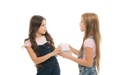 Sister rivalry. Greedy kids concept. Share gift with friend. Children envy gift. She dont want to...