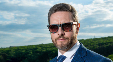 Portrait of serious man wearing sunglasses. Grizzled man with unshaven face. Professional manの写真素材