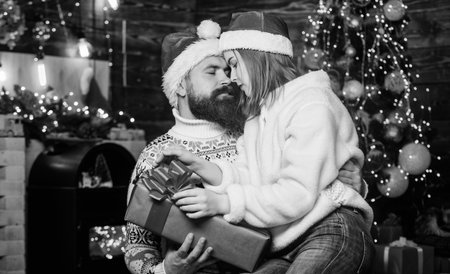 winter season shopping sales. family holiday weekend. lovers at decorated tree. celebrate new year together. xmas presents. merry christmas. love is in the air. happy santa couple in loveの写真素材