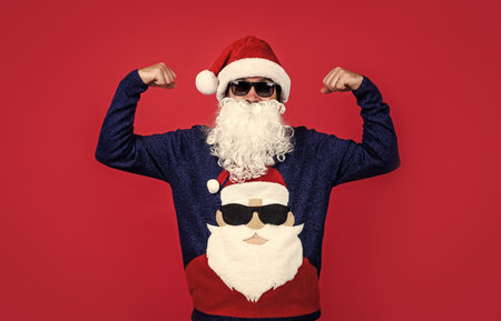 santa claus bearded man in glasses wish happy new year and merry christmas holiday ready to celebrate winter party with fun and joy full of xmas presents and gifts, partyの写真素材
