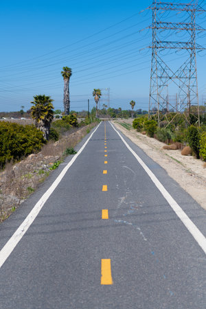 Asphalt road with pylon on roadside in countryside