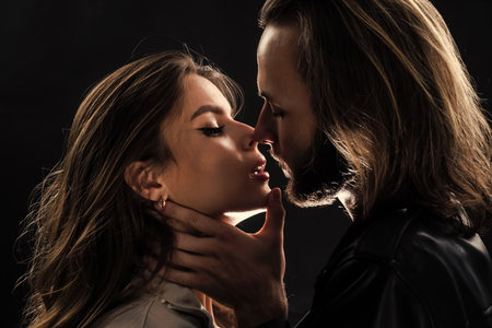 couple in love. fashionable couple closeup face portrait. bearded long hair man kiss woman.の写真素材