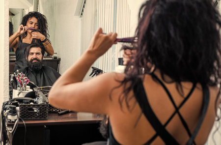 Hairdresser cut client man head in barbershop, hair careの写真素材