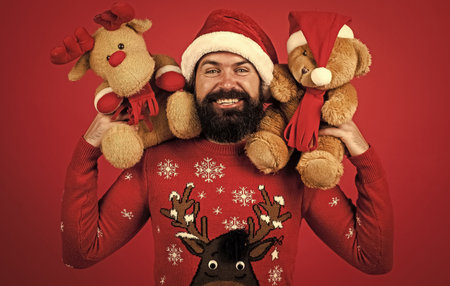 happy bearded man in santa claus costume celebrate winter holiday of chistmas and feel merry about xmas gifts, toy shopの写真素材