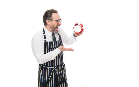 Cook looking at alarm clock shouting in panic. Restaurant owner isolated on white. Restaurant hoursの写真素材