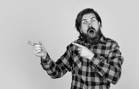 handsome guy hipster with moustache and beard, pointing fingerの写真素材