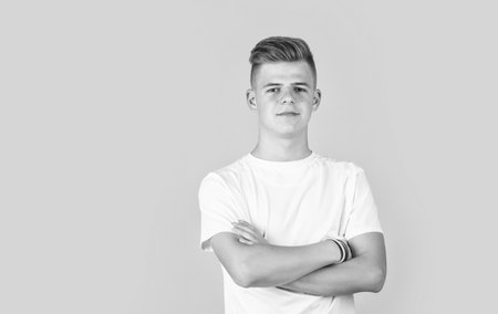 teen boy wear white casual shirt on yellow background, copy sace, fashionの写真素材
