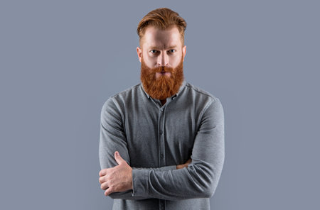 Confident Irish guy keeping arms crossed. Bearded guy with beard and moustacheの写真素材