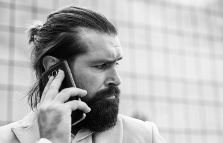 communication. confident and handsome guy. businessman. brutal bearded man portrait.の写真素材