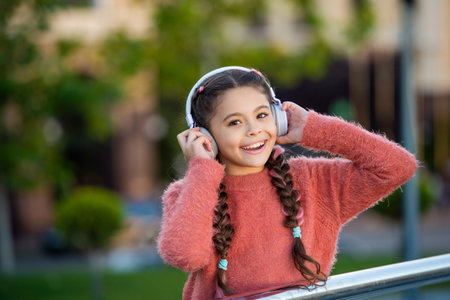 Happy teenager listening to music, leisure. Teenage girl wearing headphones. Leisure musicの写真素材