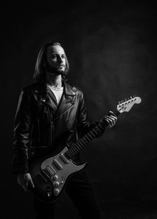 cool. masterfully playing rock music. stylish crazy man. string musical instrument.の写真素材