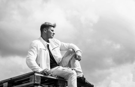young confident guy in white urban clothes outdoor, fashionの写真素材