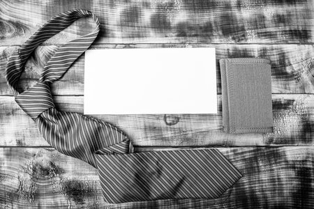 Tied formal necktie and mens wallet with piece of paper for copy space wooden background, accessoryの写真素材