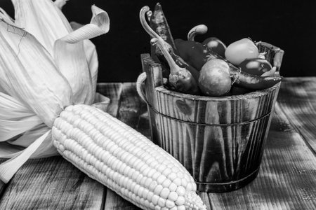 Mexican vegetables. Chili peppers and cherry tomatoes in wooden bucket.の写真素材