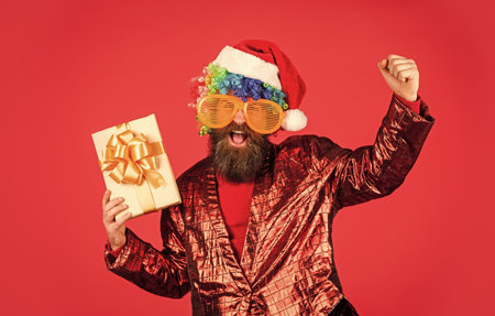 Christmas gift. Cheerful guy colorful hairstyle. Funny man with beard. Winter holidays. Disco party....
