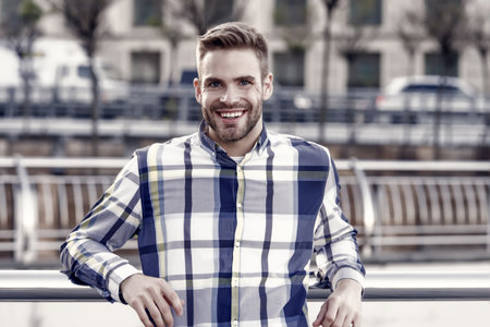Receiving care at barbershop. Unshaven guy smile in casual style outdoors. Barbershop. Barber shop. Haircut and shave salon. Barbershop service. Barbershop and groomingの写真素材